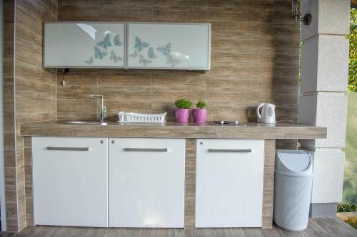 a kitchen with white cabinets and a sink at Lake House Sand in Ohrid