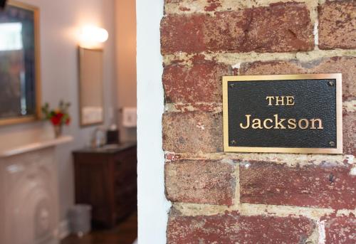 a brick wall with a sign that reads the jaxson at The Germantown Inn in Nashville