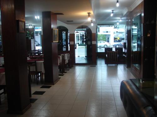 a dining room with tables and chairs in a restaurant at Cheltum Hotel in Trelew