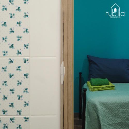 Ένα ή περισσότερα κρεβάτια σε δωμάτιο στο Rubilia Rooms Pompei