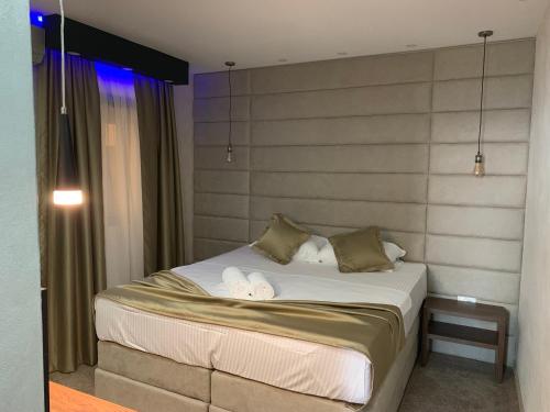 a bedroom with a bed with two towels on it at Apart Lux Beciragic in Dobra Voda