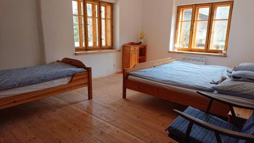 A bed or beds in a room at Chalupa U Potoka