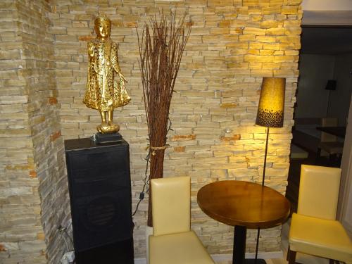 a room with a table and a trophy on a wall at Buddha Residence in Sopron