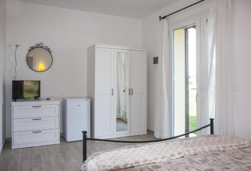 Ένα ή περισσότερα κρεβάτια σε δωμάτιο στο Agriturismo Le Villette di Cate