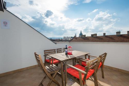 a table and chairs on a balcony with a view at Budapest Center Residence in Budapest