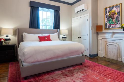 a bedroom with a large bed and a fireplace at The Germantown Inn in Nashville
