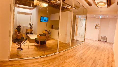 a large mirror in a room with a table at Palazzo Otello 1847 Wellness & Spa in Vicenza