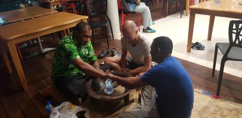 a group of three men sitting on the floor at Seatiki Resort Fiji in Sigatoka