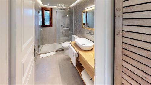 a bathroom with a sink and a toilet and a shower at Parga Inn Suites in Parga