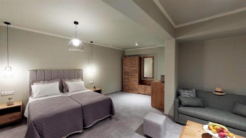 a bedroom with a bed and a couch at Parga Inn Suites in Parga