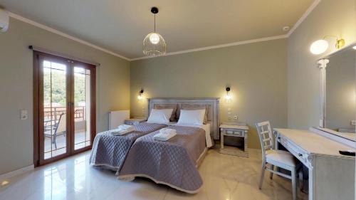 a bedroom with a bed with a desk and a desk at Parga Inn Suites in Parga