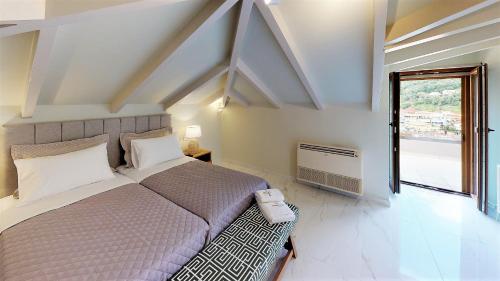 a bedroom with a large bed and a window at Parga Inn Suites in Parga