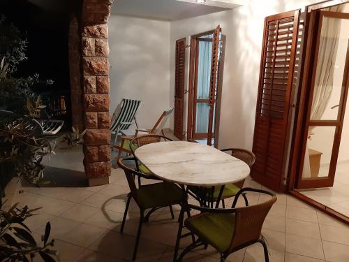 a table and chairs in a room with a table at Zoro Apartments in Sveti Stefan