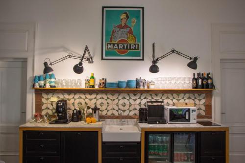 a kitchen with a counter and a sink with lights at Borgo Vergini Garden B&B in Naples