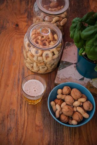 a table with a bowl of nuts and a jar of sauce at Borgo Vergini Garden B&B in Naples