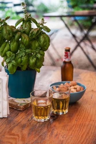 a table with two glasses of beer and a bowl of nuts at Borgo Vergini Garden B&B in Naples