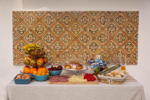 a table with fruits and vegetables and other foods on it at Borgo Vergini Garden B&B in Naples