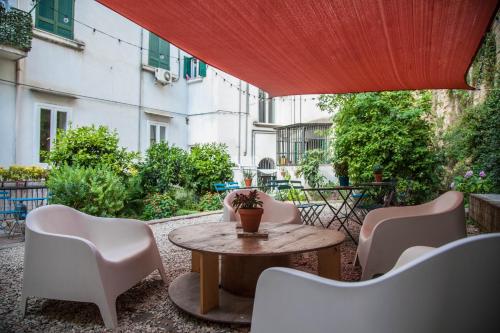 a patio with a table and chairs and a building at Borgo Vergini Garden B&B in Naples