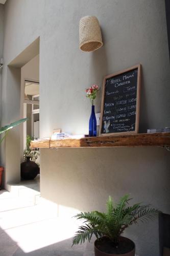 a counter with a chalkboard with flowers on it at Hotel Mamá Carlota in Querétaro