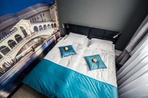 a bedroom with a bed with a painting of the eiffel tower at Apartments For You in Lębork