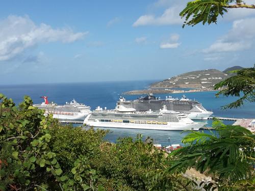 two cruise ships are docked in a harbor at Bay View condo in Philipsburg