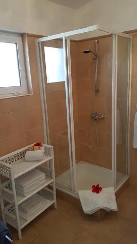 a shower with a glass enclosure in a bathroom at Villa Navita in Loulé