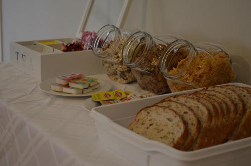 a table with bread and other snacks on it at Ellard Bed & Breakfast in Perth