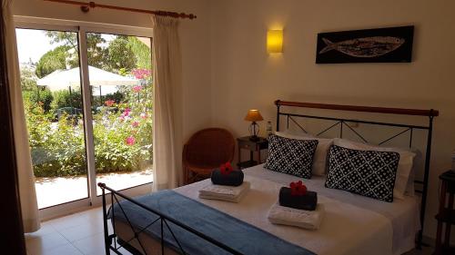 a bedroom with a bed with two boxes on it at Villa Navita in Loulé