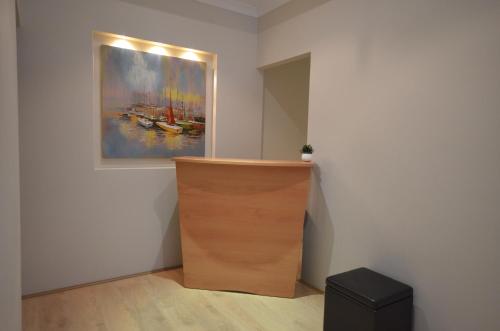 a room with a painting on the wall and a wooden cabinet at Ellard Bed & Breakfast in Perth