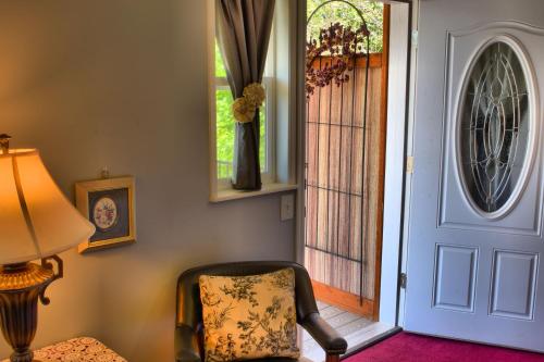 a room with a chair next to a door at Bard's Inn in Cedar City