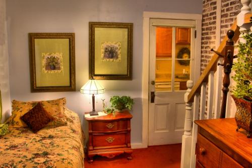 a bedroom with a bed and a table with a lamp at Bard's Inn in Cedar City