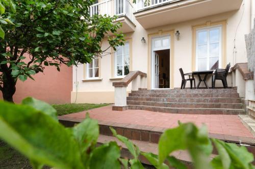 a house with a patio with a table and chairs at Pension Ibérica in Brno