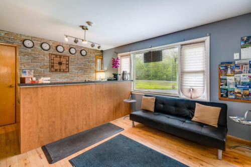 a living room with a couch and a bar at Long Sault Motel in Long Sault