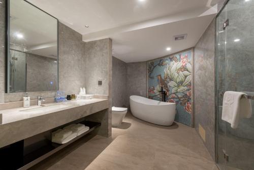 Dashen Hotel Shunde Lecong في شوند: حمام مع حوض ومغسلة ومرحاض