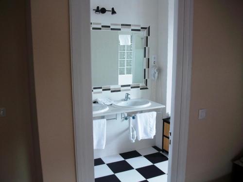 a bathroom with a sink and a mirror at Hotel Neguri in Getxo