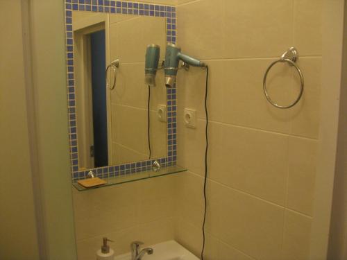 a bathroom with a shower with a mirror and a sink at Silvija House in Vilnius