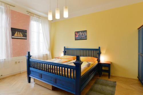 a bedroom with a blue bed in a room at Pension Ibérica in Brno
