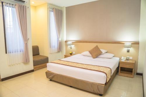 מיטה או מיטות בחדר ב-Hotel Puri Ayu