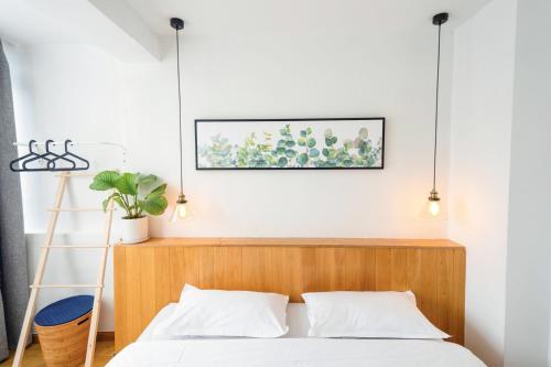 a bedroom with a bed with a wooden headboard at Xi'an Travelling with Hotel South Gate in Xi'an