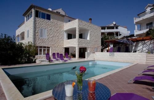 a villa with a swimming pool and a house at Villa Marijeta Hvar in Hvar