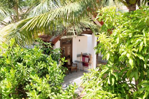 a view of a house through the trees at Hilltop House in Arugam Bay