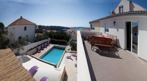a balcony of a house with a swimming pool at Villa Marijeta Hvar in Hvar