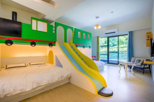 a bedroom with a bed with a train on the wall at Qing Man Homestay in Hualien City