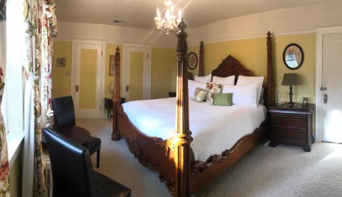 a bedroom with a large bed and a chandelier at The Inn on Knowles Hill Bed & Breakfast Hotel in Sonora