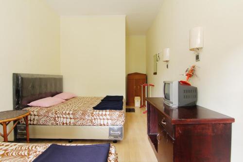 Postel nebo postele na pokoji v ubytování Hotel Wijaya 3 Kaliurang