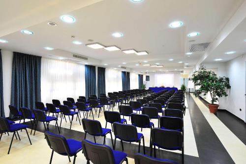 a room with rows of chairs and a long table at Best Western Blu Hotel Roma in Rome