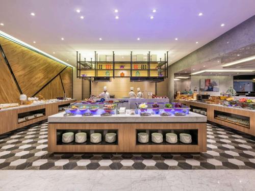 a restaurant with a table with plates of food at Novotel Suites Shanghai Hongqiao in Shanghai