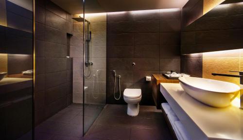 a bathroom with a sink and a shower and a toilet at Hotel Armada Petaling Jaya in Petaling Jaya