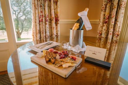 a glass table with a plate of food on it at Chateau Yering in Yarra Glen