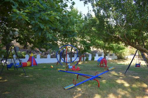 a playground in a park with a swing set at Hotel Zachos in Troulos